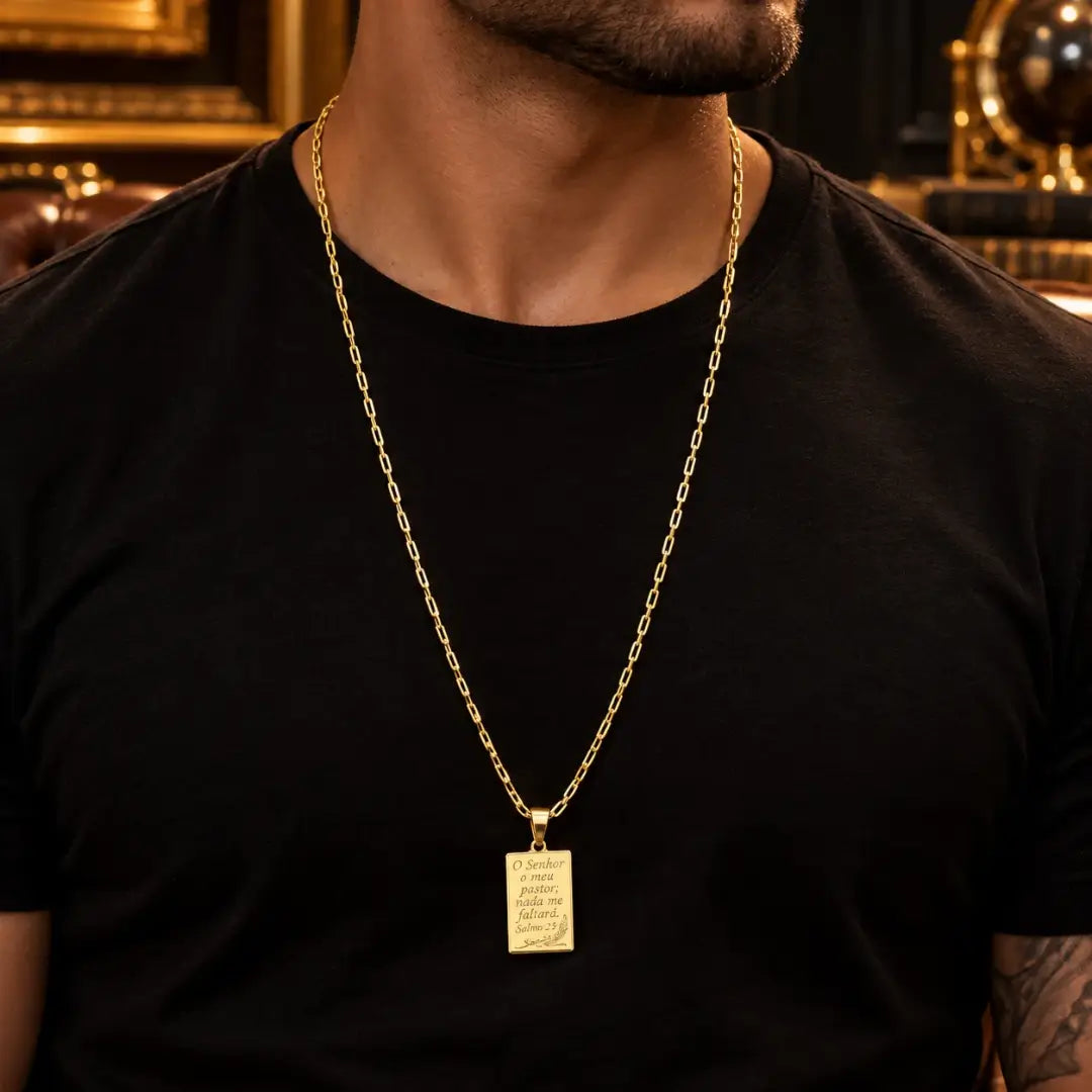Homem usando colar masculino Salmos 23 banhado a ouro 18K com corrente Corrente Veneziana pingente dourado sobre camiseta preta.
